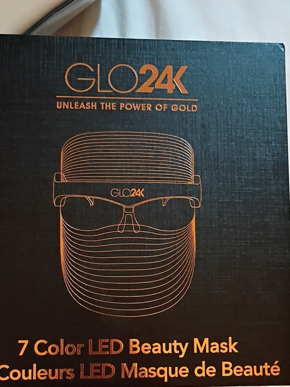 a:glow GLO24K LED Beauty Mask in black with gold accents